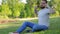 Young man sitting in the park with his diary