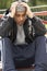 Young Man Sitting In Playground