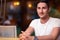 Young Man Sitting in a Restaurant