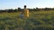 Young man sitting in yoga pose at green grass in the meadow and meditates. Muscular guy relaxing in lotus pose at nature