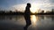 Young man skating on frozen river during sunset time. Guy shod in figure skates sliding on icy lake during training