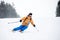 Young man skier in ski sportswear doing skillful maneuvers on skis. Skiing and turning on snow-covered mountain descent