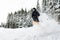 Young man skiing downhill trough deep powder snow.