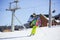 Young man skiing downhill on winter resort