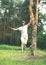 young man is slacklining walking and balancing on a rope, slackline outdoors