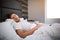 Young man sleeping in bed in the morning. Calm and peaceful. Early morning. Daylight.