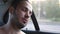 Young man sleeping inside moving car during long journey. Portrait of tired passenger traveling by car at summer evening