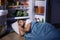 Young man sleeping near refrigerator