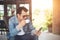 Young man with smartphone smiling relaxing at cafe.