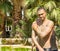 The young man is smeared with mud near the thermal spring. Turkey. Karahayit (near of the city Denizli) -