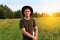 Young man smile farmer in cowboy hat at agricultural field on sunset holding tablet. Male on nature background, outdoors