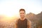 Young man smiling while on an early morning nature hike