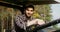 Young man smiling looking at the camera while sitting an agricultural car