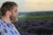 young man smokes on a blurred background of a lavender field. Lifestyle