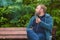 Young man smokes tobacco pipe in park