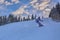 Young man snowboarder running down the slope in Karakol mountains.