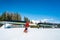 Young man snowboarding down the mountains ski resort.