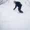 Young man snowboarding down a slope