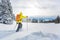 Young man snowshoeing in high mountains