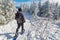 Young man snowshoeing in winter, in the Quebec eastern township