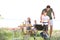 Young man with son cooking tasty food on barbecue grill outdoors. Family picnic