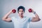 Young man sports appearance shows muscles and holds apples in his hands