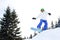 Young man in sportswear snowboarding over pine trees background