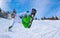 Young man in sportswear snowboarding over pine trees background