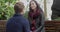 Young man squatting down talking to his girlfriend