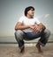 Young man squatting on the sand