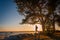 Young man stand under the tree during sunset in wintertime in South Estonia