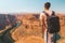 Young man standing at the edge of the Horse Shoe Bend cliff