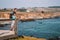 Young man standing on the edge of the pier by the Californian