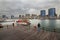 A young man standing on his back admires the river in the old Dubai Creek. Back view