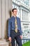 Young man standing inside office building in New York City, looking forward