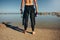 Young man standing on lake wearing wetsuit