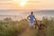 Young man standing near bicycle in morning sunrise with wonderf