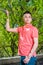 Young man standing outdoors by tree in New York City, looking forward