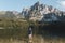 Young man standing on rock in Laudachsee with alps mountain. Summer Austria landscape