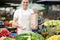 Young man standing on stall fresh food