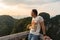 Young man standing in Tiger Cave Temple view point and looks from the high point on