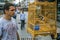 A young man standing by the wild songbirds in cages at the market. Travel around Asia.