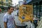 A young man standing by the wild songbirds in cages at the market. Travel around Asia.