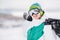 Young man standng on the snow with snowboard