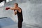 Young Man Stands In Boxing Pose And Doing Punching Workout. Handsome Caucasian Sportsman.