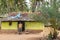 Young man stands in front of dwelling, Belathur Karnataka India.