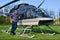 Young man stands next to small helicopter