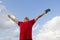 Young man staying with raised hands