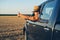 Young man in straw hat driving truck. Life on a farm.