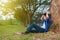 Young man in stress situation when reading a book in park